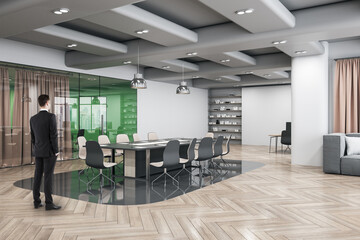 Poster - Attractive thoughtful young european businessman standing in wooden and concrete office interior with furnituire and window with city view. CEO, executive and consulting concept.