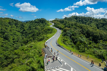 the zigzag road is similar to the number 3. this road is built on a mountain, past the forest in nan