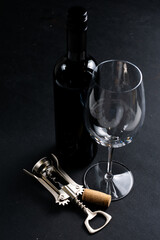 Wall Mural - Wine glass and wine bottle on dark background