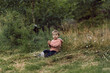 © Yulia Raneva - cute little caucasian boy sitting alone on grass