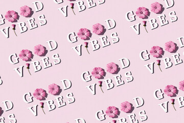 Wall Mural - Good vibes. Creative inspire pattern made with motivational quotes from white letters and beauty natural flowers on pink background