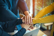 © brain2hands - A group of young people hands coordination is a symbol of unity within the organization to strive for the success of the team and the company. The concept of unity within a business.
