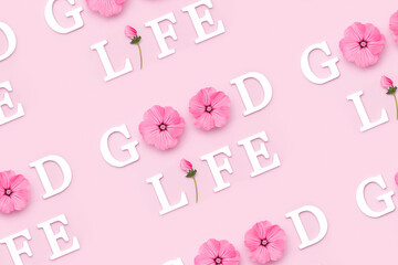 Wall Mural - Good life. Creative inspirational pattern made with motivational quotes from white letters and beauty natural flowers on pink background