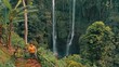 Active lifestyle travel people explore beautiful Bali destination, the biggest and most beautiful waterfall Bali Sekumpul hidden in tropical rainforest jungle on nature background 4K Aerial view