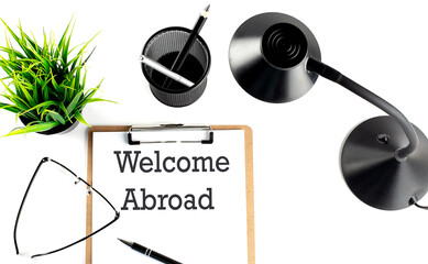 WELCOME ABROAD text on a clipboard on the white background