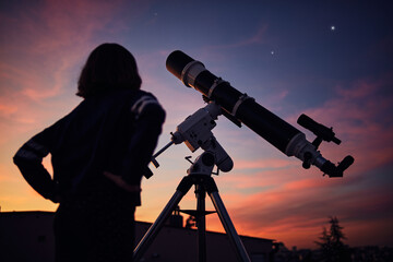Canvas Print - girl with astronomical telescope stargazing under twilight sky.