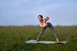 © serhiibobyk - Relaxed woman in activewear training on yoga mat with amazing view on summer mountains. Morning exercise on fresh air. Healthy lifestyles concept.
