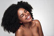 Leinwandbild Motiv Joyful young black lady with perfect skin smiling with closed eyes