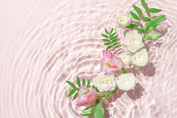 Wall Mural - Sunny summer cosmetic background with flowers. The texture of the water surface.