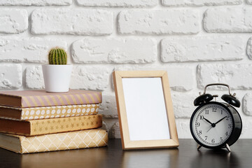 Poster - Books with picture frame on wooden table