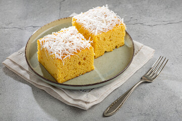 Poster - Sliced ​​coconut cake on the table.