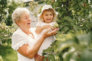 Wall Mural - Grandmother and granddaughter enjoyed in the garden