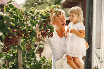 Wall Mural - Grandmother and granddaughter enjoyed in the garden