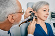 © Peakstock - Otolaryngologist doctor checking senior woman's ear using otoscope or auriscope at medical center. Hearing test for older people, otoscopy