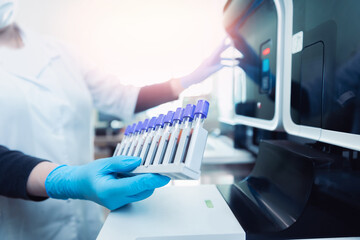 Wall Mural - medical scientist loading samples in robot machine for biochemical automatic testing blood laborator