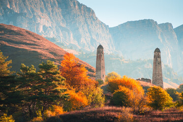 Wall Mural - Old stone tower complex in Erzi national park in Ingushetia, Caucasus, Russia. Beautiful autumn landscape at sunrise.