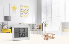 Digital Hygrometer With Thermometer On White Table In Children's Room. Optimal Humidity Level For Kids