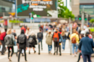 People crossing street in city, blurred view