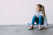 © F8  \ Suport Ukraine - Smiling little girl sitting on a skateboard, and props up a head a hand, gazing at the camera with satisfaction and happiness. Positive emotions of children
