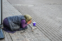 Beggar Woman On The Street. Poor And Homeless Elderly Woman Beg For Money In The City. Social Problem. 