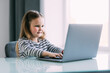 © F8  \ Suport Ukraine - Little girl learning English indoors at online lesson on laptop