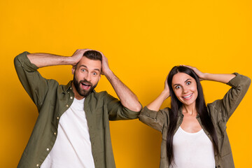 Canvas Print - Photo of young spouses hands touch head reaction omg wow news unbelievable isolated over yellow color background