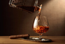 Cognac And Cigar On An Oak Table.