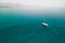 A Lonely Yacht Sailing In Turquoise Waters Of The Mediterranean Sea, A Vacation Yacht