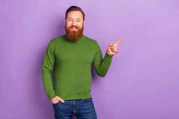 Wall Mural - Photo of cheerful friendly young male point finger empty space promoting product isolated on violet color background