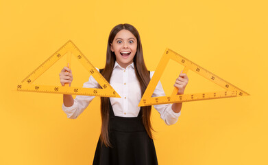 Wall Mural - amazed teen girl in school uniform hold mathematics triangle for measuring, high school