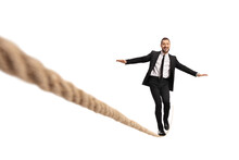 Businessman Walking On A Tightrope And Smiling