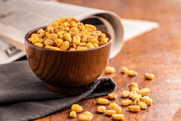 Sticker - Roasted salted corn snack in bowl on wooden table.