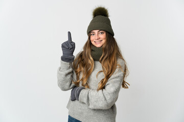 Young caucasian woman with winter hat isolated on white background pointing up a great idea