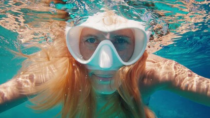 Sticker - Portrait of the young woman in white mask swimming underwater in the tropical sea in the Maldives