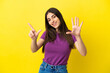 © luismolinero - Young caucasian woman isolated on yellow background counting seven with fingers