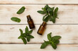 © Liami - Melissa essential oil bottles on wooden background, top view