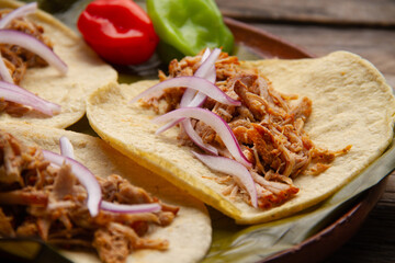 Wall Mural - Cochinita pibil tacos in banana leaves with habanero peppers. Mexican food