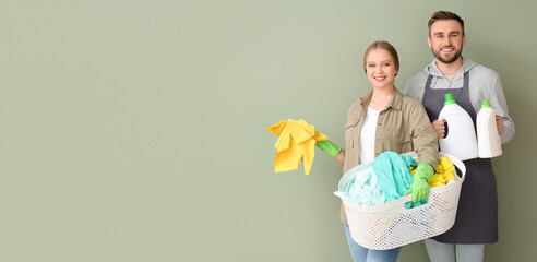 Sticker - Young couple with laundry and detergents on color background with space for text