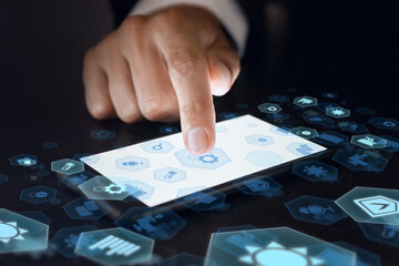 Canvas Print - Man with mobile phone using futuristic interface of smart home automation on dark background, closeup