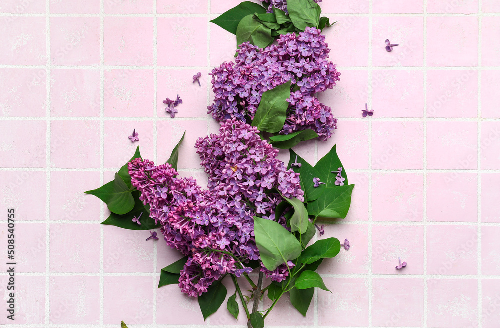 Purple lilac flowers on pink tile background