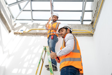 Poster - Construction worker wearing safety harness and safety line working at high place in new house under construction.