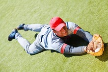 Baseball Player Diving To Catch The Ball