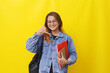 © ArvStd - Young asian college student standing while holding books with calling hand gesture