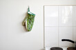 © Austockphoto - Crocodile oven glove hanging on a white kitchen wall