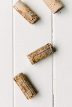 Old Corks On A White Wooden Background