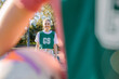 © Austockphoto - close up shot of a young woman framed in a blurry arm and net ball in the foreground