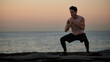 © Austockphoto - Male doing stretch exercise beside ocean