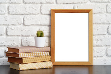 Poster - Books with picture frame on wooden table
