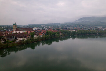 City of Bad Säckingen, Baden-Württemberg, with church and Rhine River on a cloudy spring day. Photo taken May 6th, 2022, Stein, Switzerland.