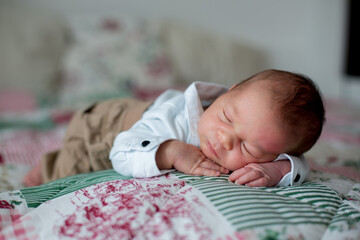 Canvas Print - Beautiful little newborn baby boy, dressed as little gentlemen, sleeping in bed